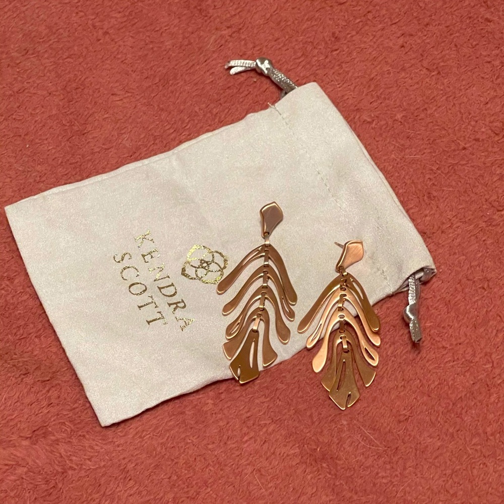 Rose gold Kendra Scott palm leaf earrings.